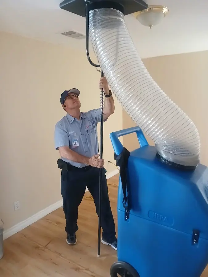 Furnace Tune-Up technician using HEPA equipment in Iowa Colony